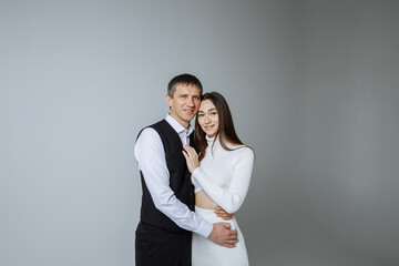 A man and a woman on a gray background of a photo studio