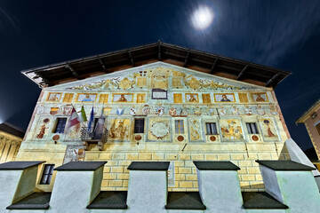 The frescoed facade of the palace of the Magnificent Community of Fiemme di Cavalese. Fiemme Valley, Trentino, Italy.