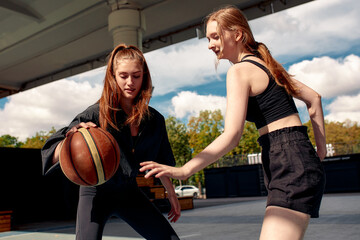 Fototapeta na wymiar Bonding Through Basketball: Two Friends on court