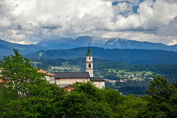 Fototapeta na wymiar The church of the mountain village of San Sebastiano. Folgaria, Alpe Cimbra, Trentino, Italy.
