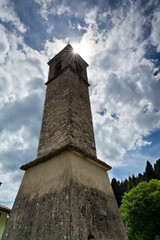 Fototapeta na wymiar Romanesque bell tower in the village of San Sebastiano. Folgaria, Alpe Cimbra, Trentino, Italy.
