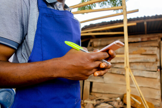 young african carpenter standing holding working calling
