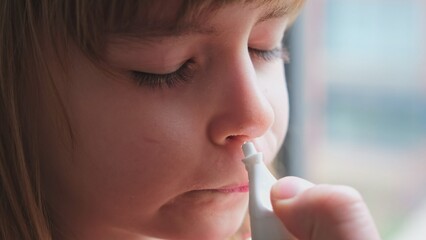 Mother Cleaning Daughter Stuffy Blocked Nose with Physiological Saline Sodium Chloride Solution Medical Spray