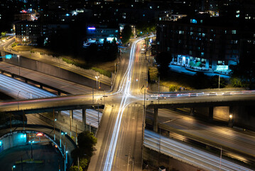 Aerial city streets and intersections long exposure light trails at night. 