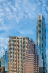 Modern apartments or flats in downtown Austin Texas with cloudy blue sky view. City skyline seen on a beautiful sunny day with contemporary architecture stuctures.