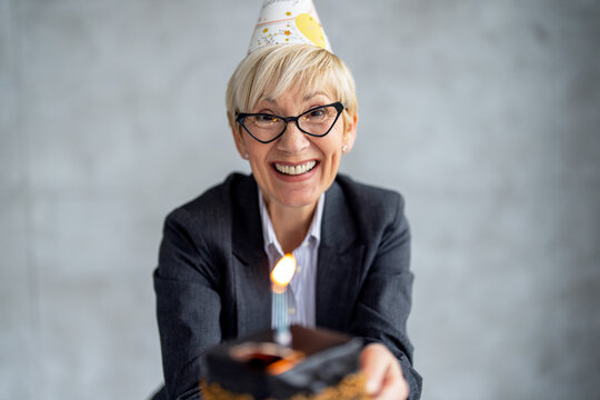 Middle Aged Business Woman Showing Celebrate Birthday At Office, Holding Cake