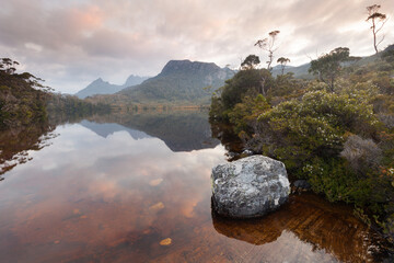 Beautiful sunrise over Lake Lilla. Cradle Mountain Lake St Clair National Park, Central Highlands of Tasmania, Australia. Peaks are reflected in the lake