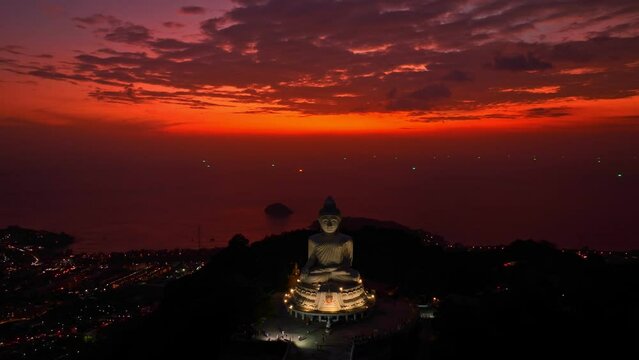 aerial view amazing red sky at Phuket big Buddha in quite twilight.  .Twinkling lights along the beach and in various towns around Phuket Island. .creative travel concept. stunning red sky 