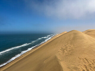 Sandwich Harbour in Namibia at the coast of the Atlantic Ocean. Sandy beach.