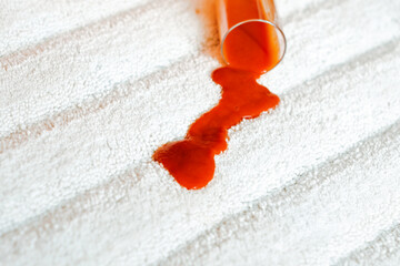 A red stain on a white carpet indoors. Spilling juice on the floor. closeup. daily life stain concept. High quality photo