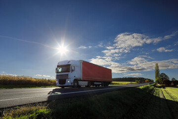Truck transport on the road at sunset and cargo 