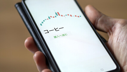 An investor analysing an ETF on a screen. Funds stocks exchange with Japanese text: coffee, buy
