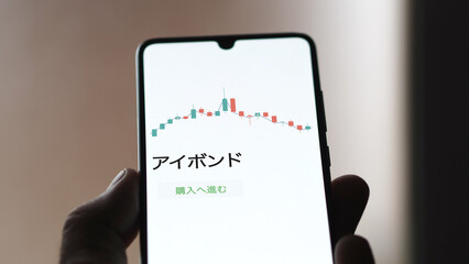 An investor analysing an ETF on a screen. Funds stocks exchange with Japanese text: ibond, buy