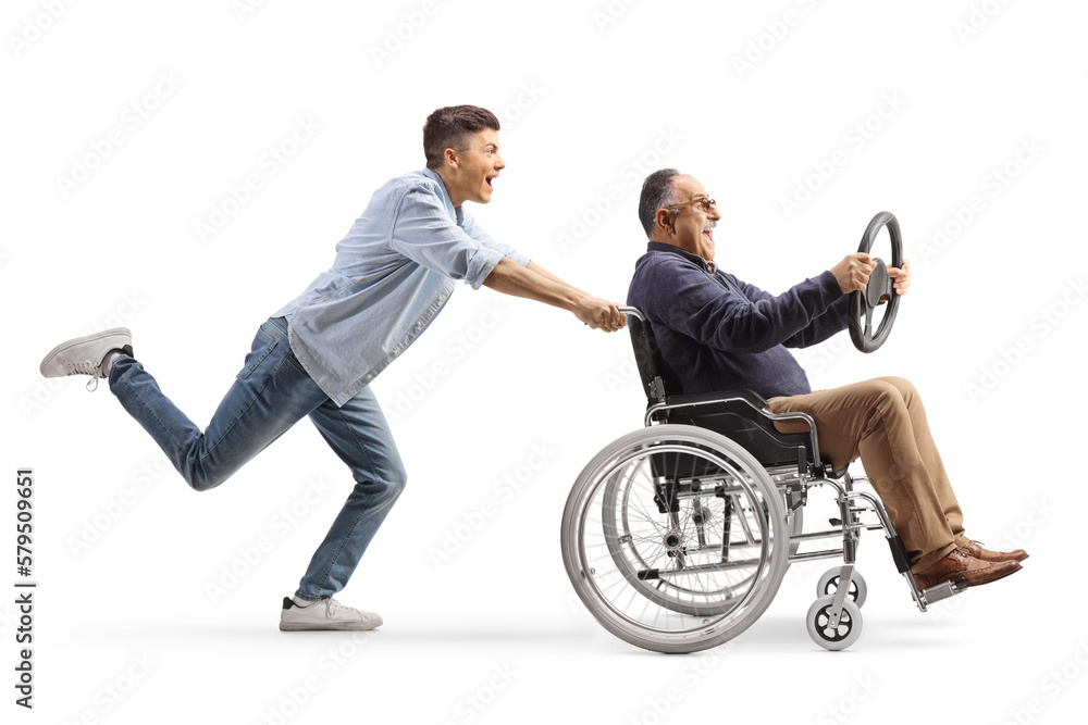 Poster Full length profile shot of a guy pushing a mature man in a wheelchair holding a steering wheel