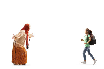 Muslim woman in ethnic clothes waiting to hug a schoolgirl