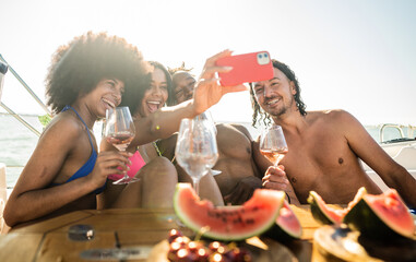 Group of multiracial friends enjoy the boat tour and taking selfie to immortalizing the beautiful...