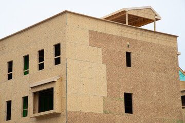 Fototapeta na wymiar new condominium or apartment construction wood plywood house