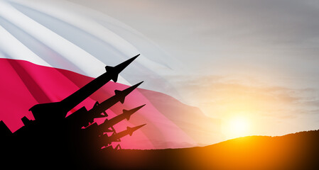 The missiles are aimed at the sky at sunset with Polish flag. Nuclear bomb, chemical weapons, missile defense.