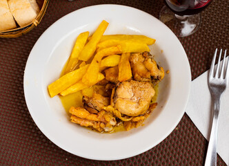 Fresh portion of fried chicken with potatoes served on plate.