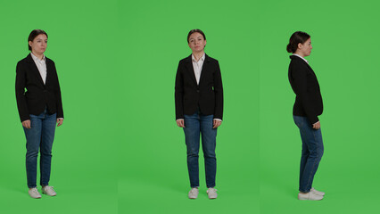 Obraz premium Full body green screen backdrop of business woman, posing on camera. Female office employee in suit standing over greenscreen background, being confident and optimistic company worker.