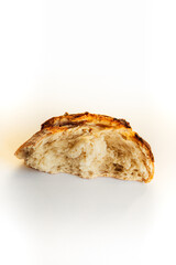 ripped half of sourdough loaf on white