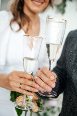 Wedding ceremony cheers. Bride and groom hands clink glasses of champagne, sparkling wine

