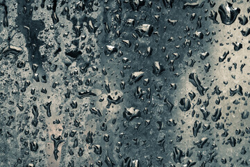 Water drops on dark blue glass, for background, wet glass texture