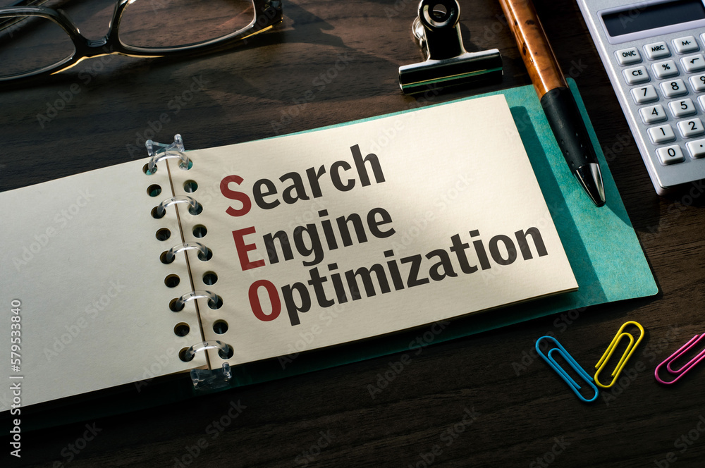 Poster there is a notebook with the word search engine optimization. it is eye-catching image.