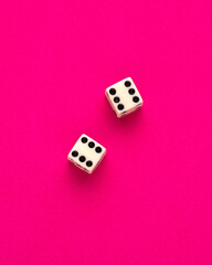Dice for board game on rhodamine red background - Entertainment in casino