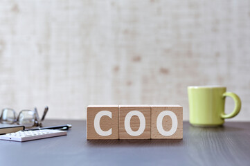 There is wood cube with the word COO. It is an acronym for Chief Operating Officer an eye-catching image. - obrazy, fototapety, plakaty