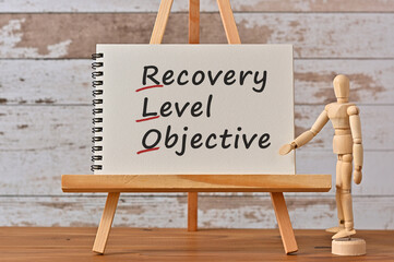 There is notebook with the word Recovery Level Objective. It is an eye-catching image.