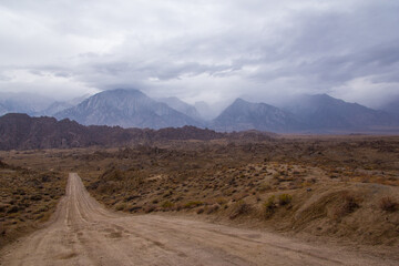 storm clouds roll through the eastern Sierra Nevada mountains and the Alabama hills, near lone pine, California