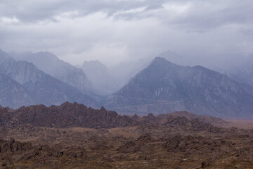 storm clouds roll through the eastern Sierra Nevada mountains and the Alabama hills, near lone pine, California