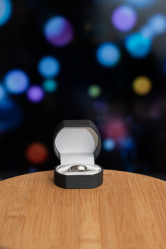 Wedding ring over wood table and background abstract blue dark vertical image