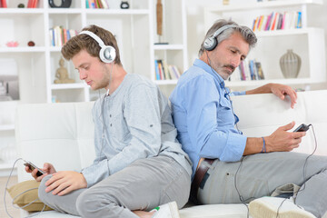 father and son busy with gadgets