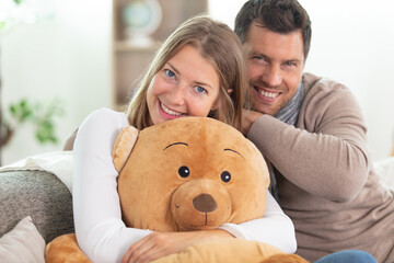 young couple man and woman sitting on sofa studio