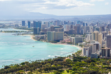 View of the city of Honolulu from above at the top of Diamond Head Crater, in Oahu, Hawaii. Sail boats and buildings.