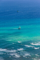 View of the city of Honolulu from above at the top of Diamond Head Crater, in Oahu, Hawaii. Sail boats and buildings.