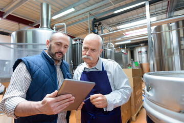 Fototapeta two concentrated men in fermenting section obraz