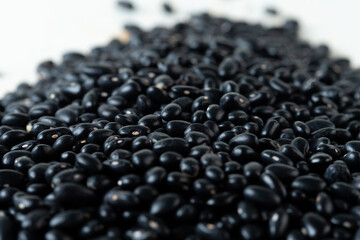 Pile set of black bean, black grain beans pouring down abstract cloud group. Beautiful complete seed pea bean, food object design. Selective focus freeze shot white background isolated