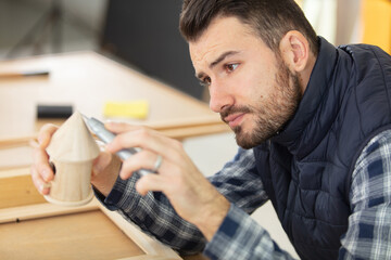 skilled carpenter works on a wooden object