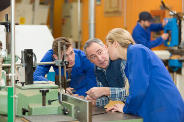 engineer talking to trainees in factory