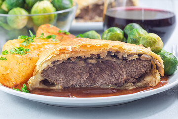 Beef Wellington with mushroom Duxelles, served with brussels sprouts and Chateau potato, closeup
