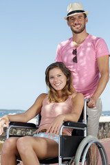 Obraz na płótnie Canvas a man and a woman in wheelchairs outdoors