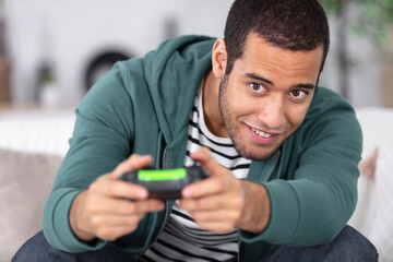 excited young handsome man playing video game © auremar
