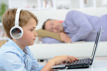 Fototapeta premium young boy using the laptop