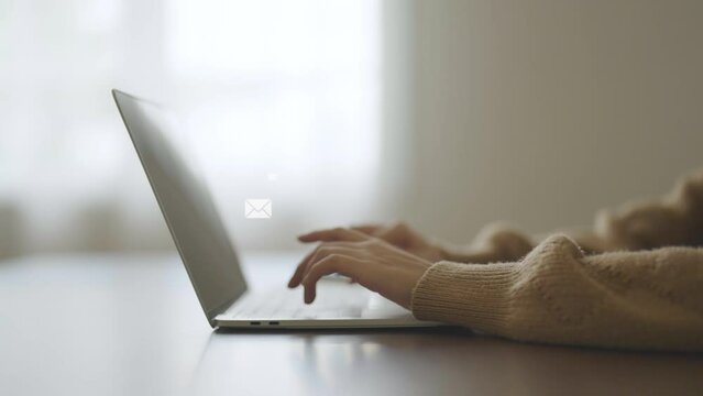 Email marketing and newsletter concept. Hand of woman using computer laptop and sending online message with email icon