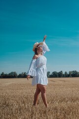 woman in white sunglasses posing outdoors in a beautiful dress
