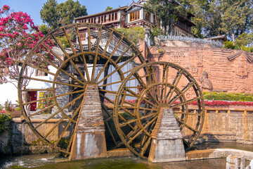 Scenic buiding in the Old Town of Lijiang. Lijiang is a popular tourist destination of China, Asia. Wheel