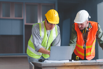 Contractor coworkers working together on remodeling home, Hold a radio to command subordinates.